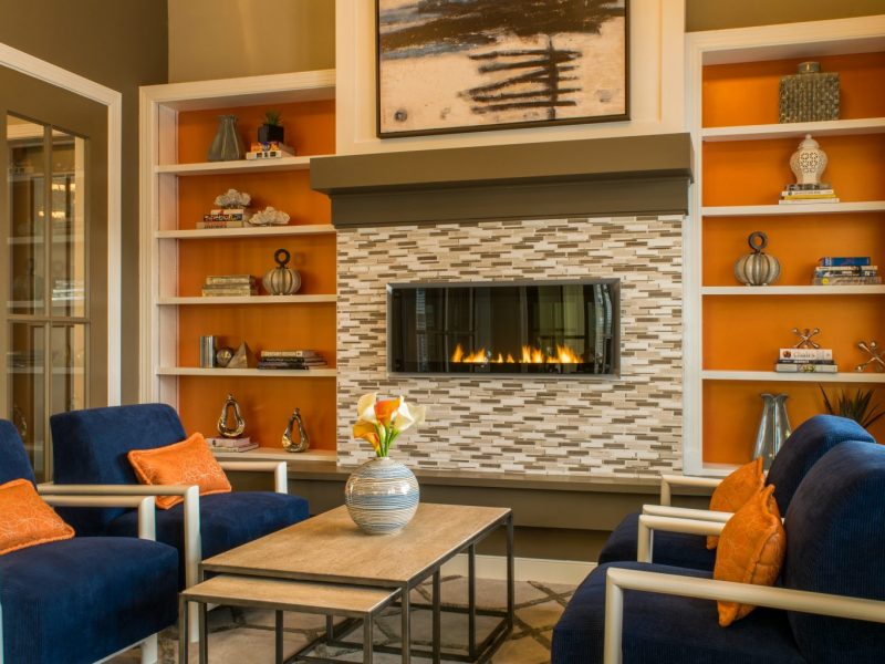 This image shows a cozy living room with a customize and durable stone fireplace decoration.